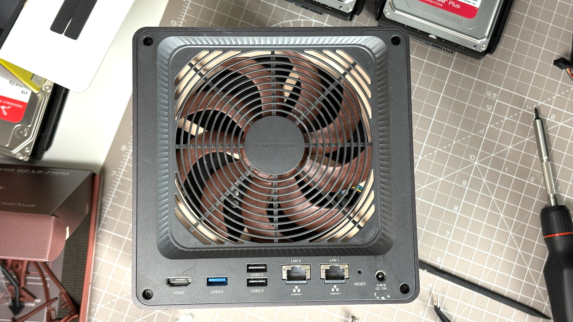UGreen NASync DXP4800 Pro on a desk with multiple HDDs installed.
