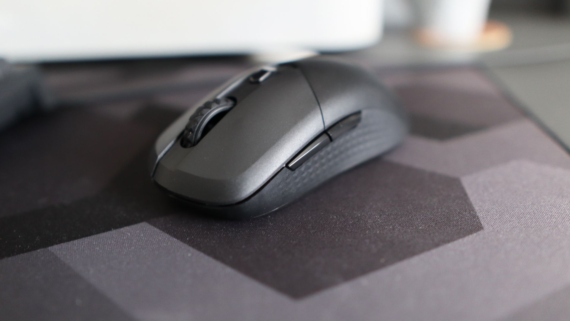MSI Versa 300 Wireless 8K on a desk and held in a hand.