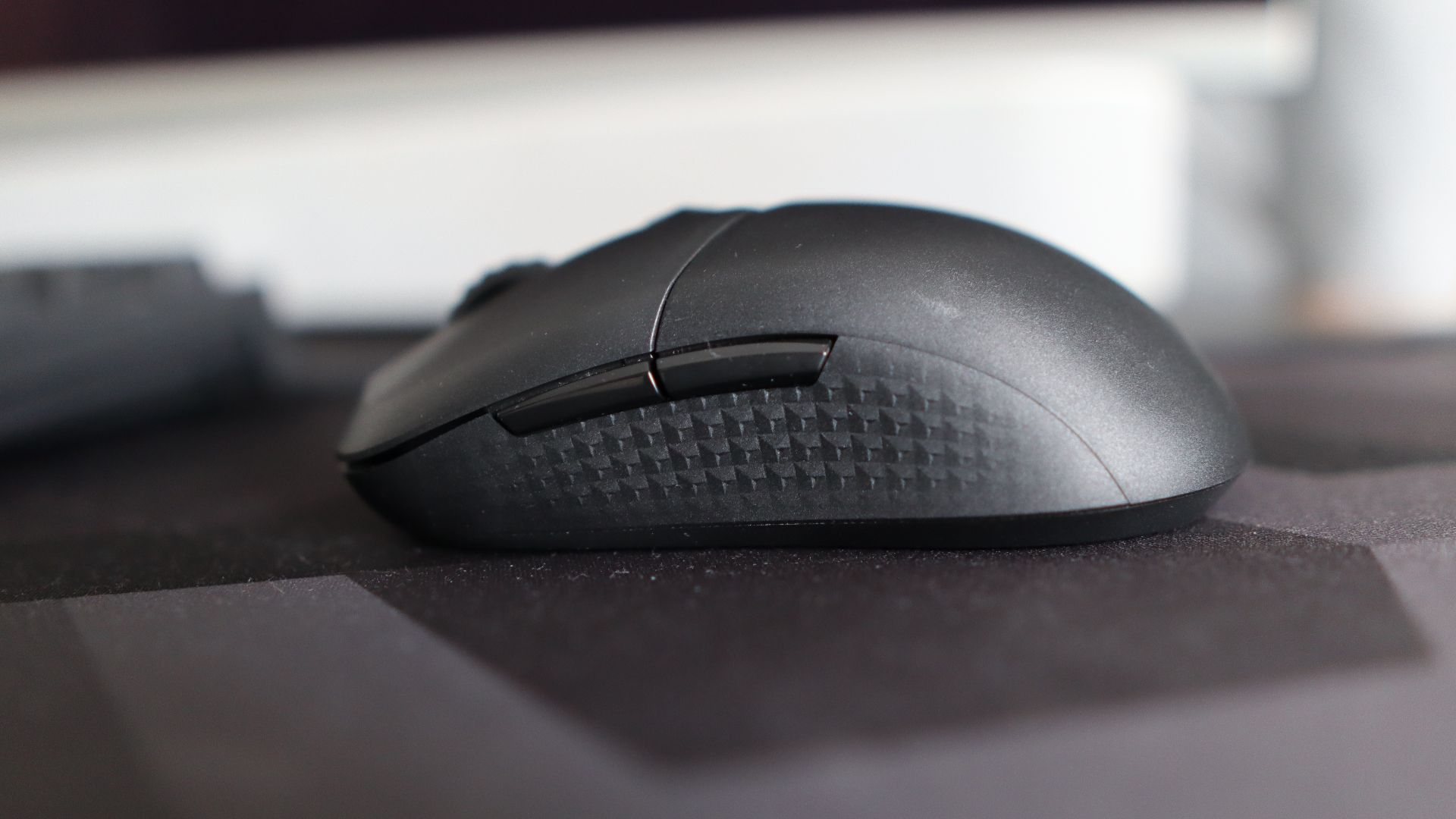 MSI Versa 300 Wireless 8K on a desk and held in a hand.