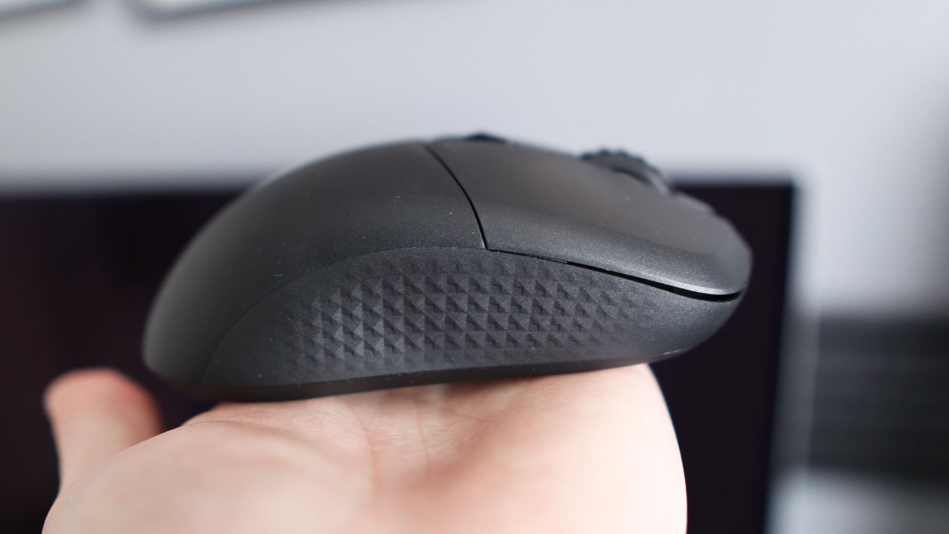 MSI Versa 300 Wireless 8K on a desk and held in a hand.