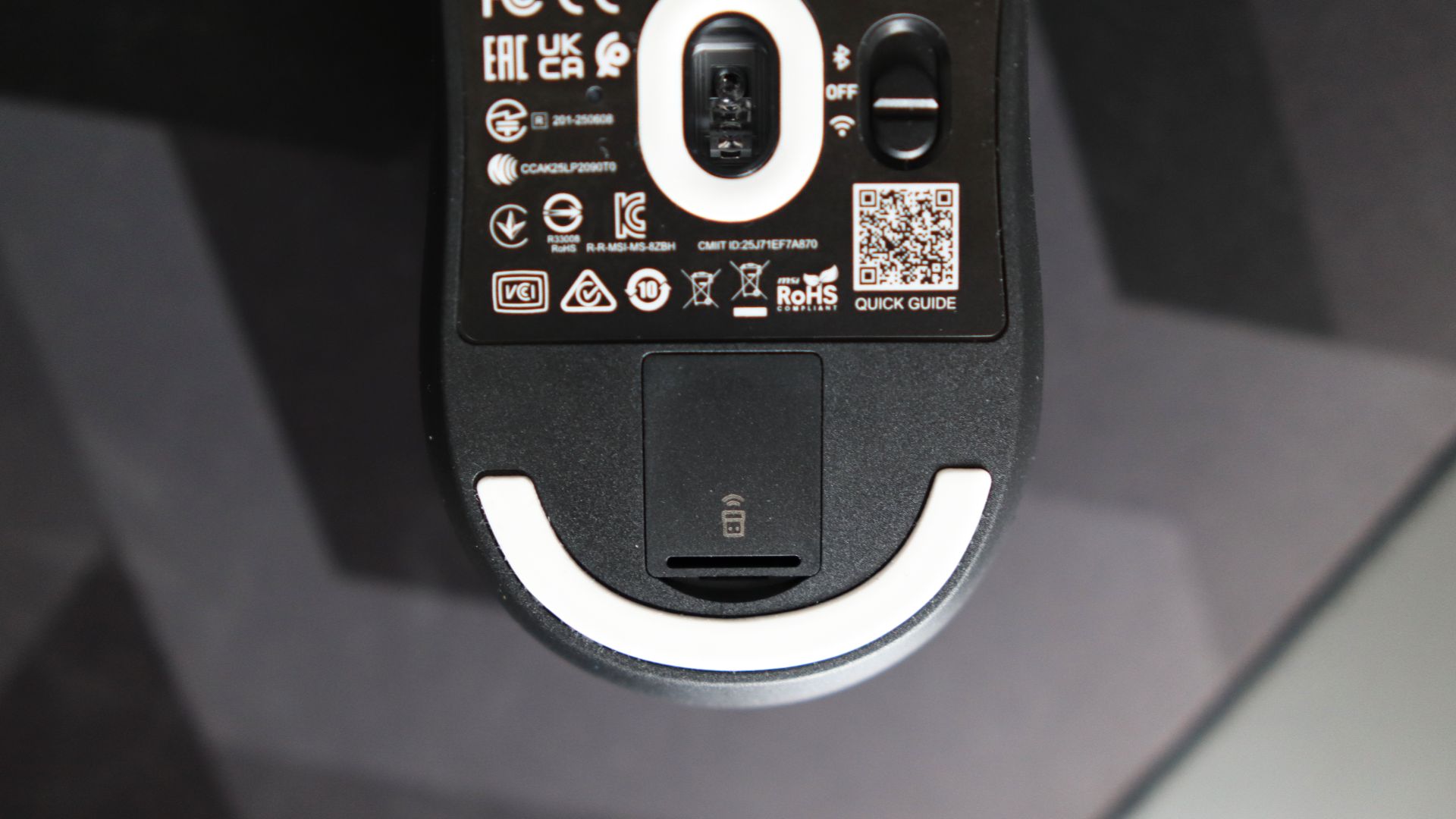 MSI Versa 300 Wireless 8K on a desk and held in a hand.