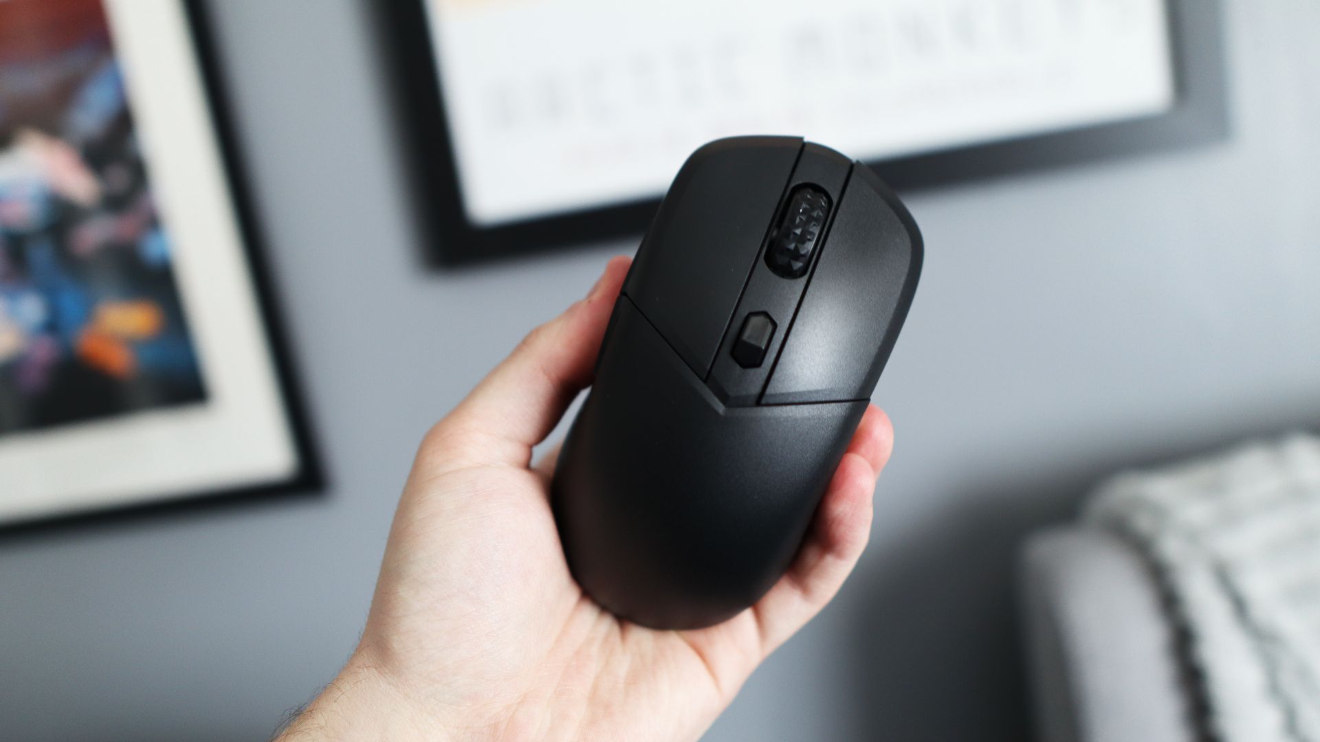 MSI Versa 300 Wireless 8K on a desk and held in a hand.