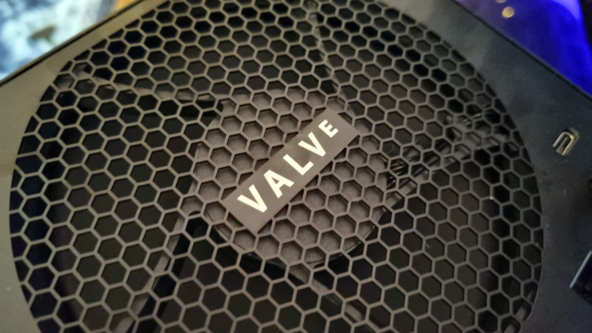 The rear fan cover of the Steam Machine, with the Valve logo in the middle