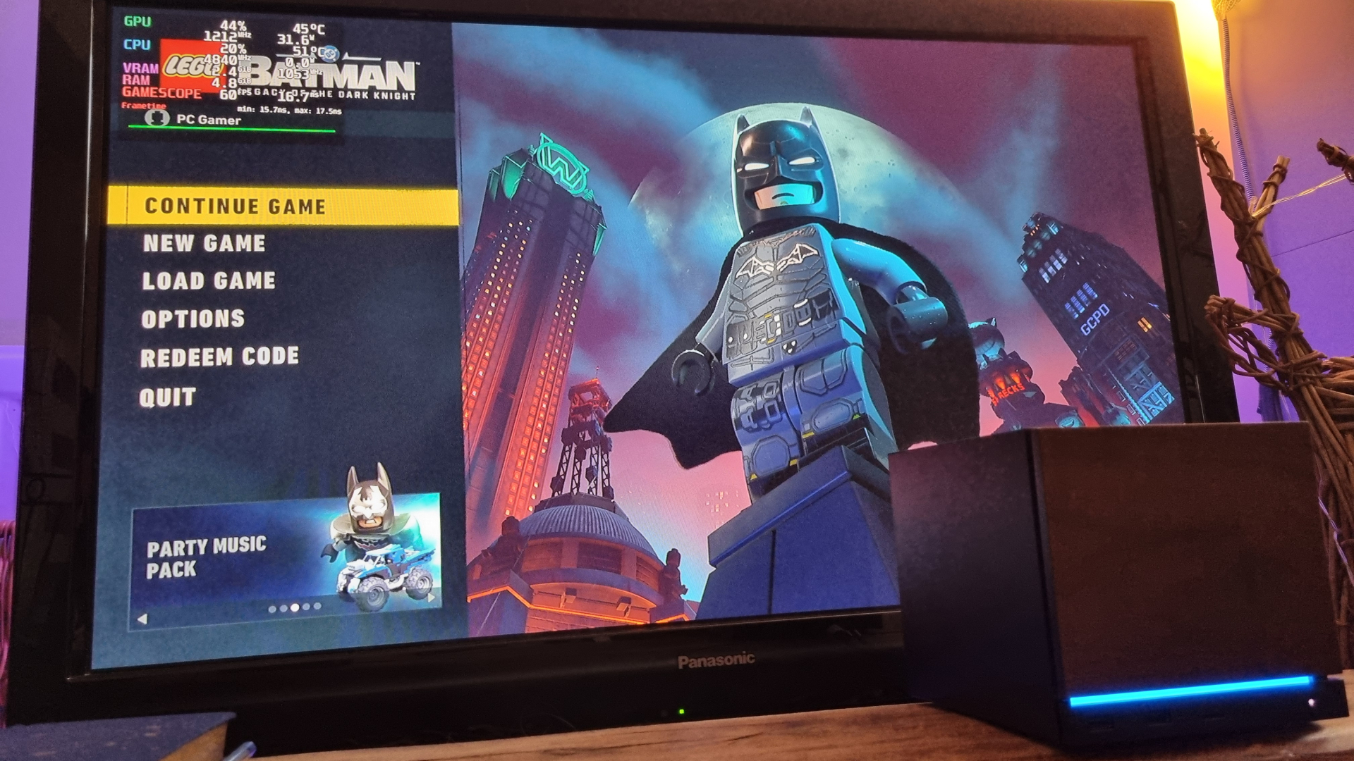A Steam Machine running Lego Batman: Legacy of the Dark Knight on a TV
