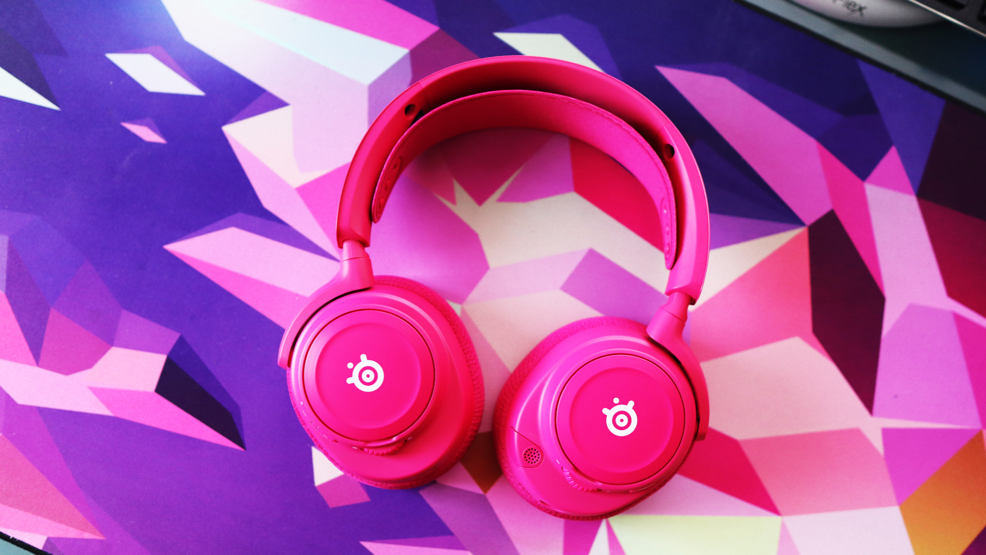 SteelSeries Arctis Nova 7X Wireless Gen 2 in pink on a mouse pad.