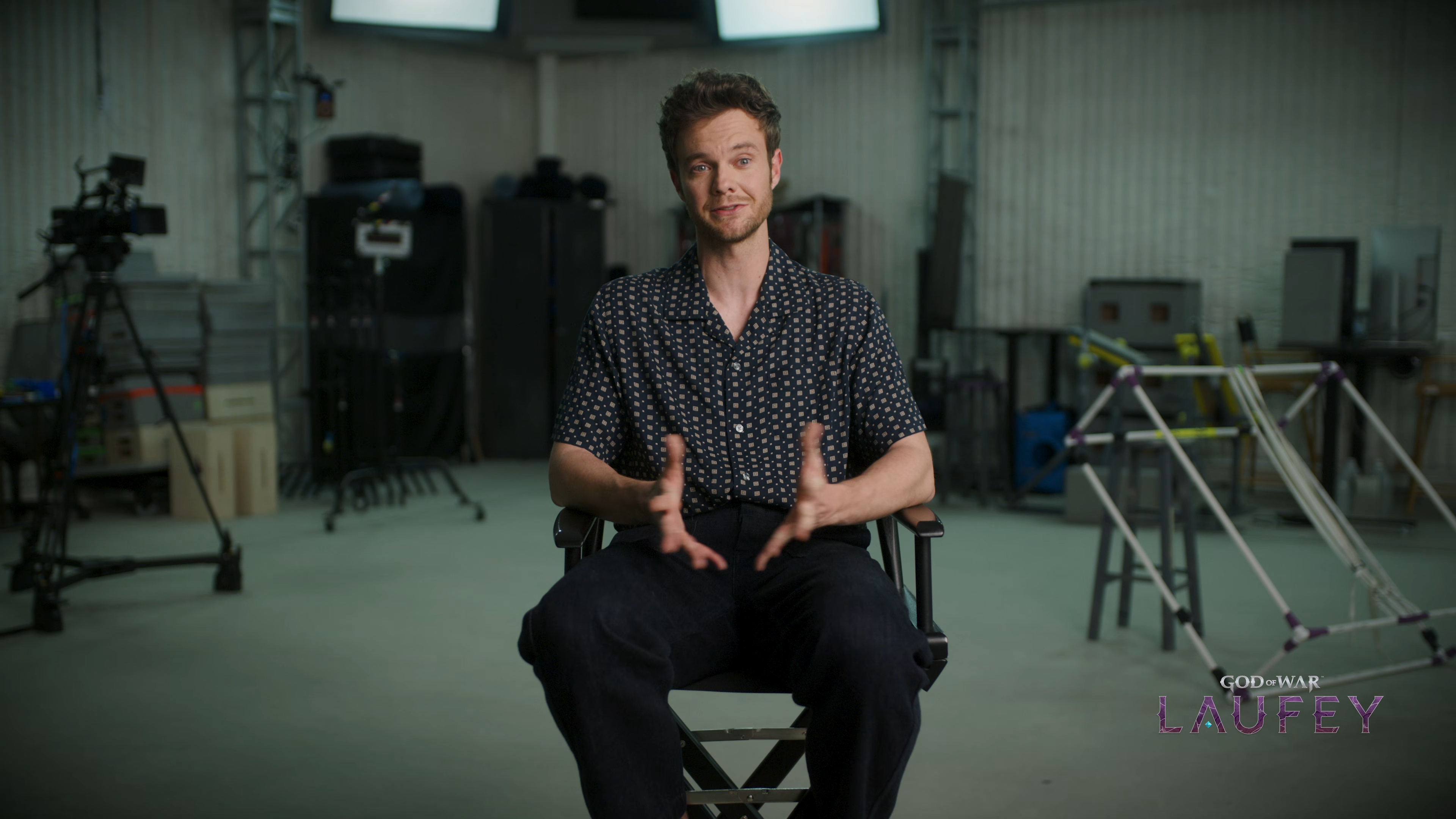 Jack Quaid being interviewed about his performance in God of War Laufey, his cubic mocap rig visible in the background.