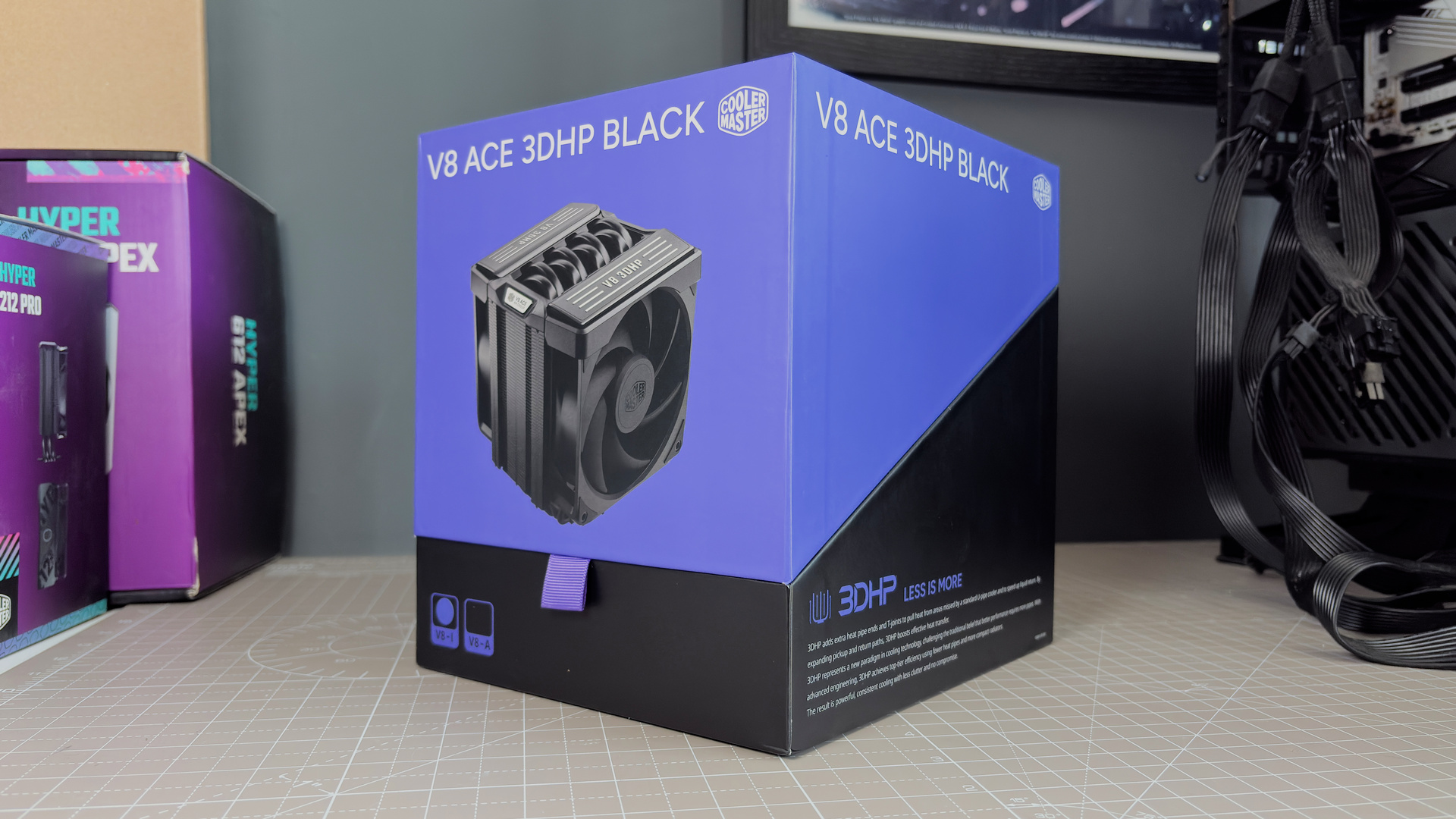 The Cooler Master V8 Ace 3DHP installed on a test bench and on its box.