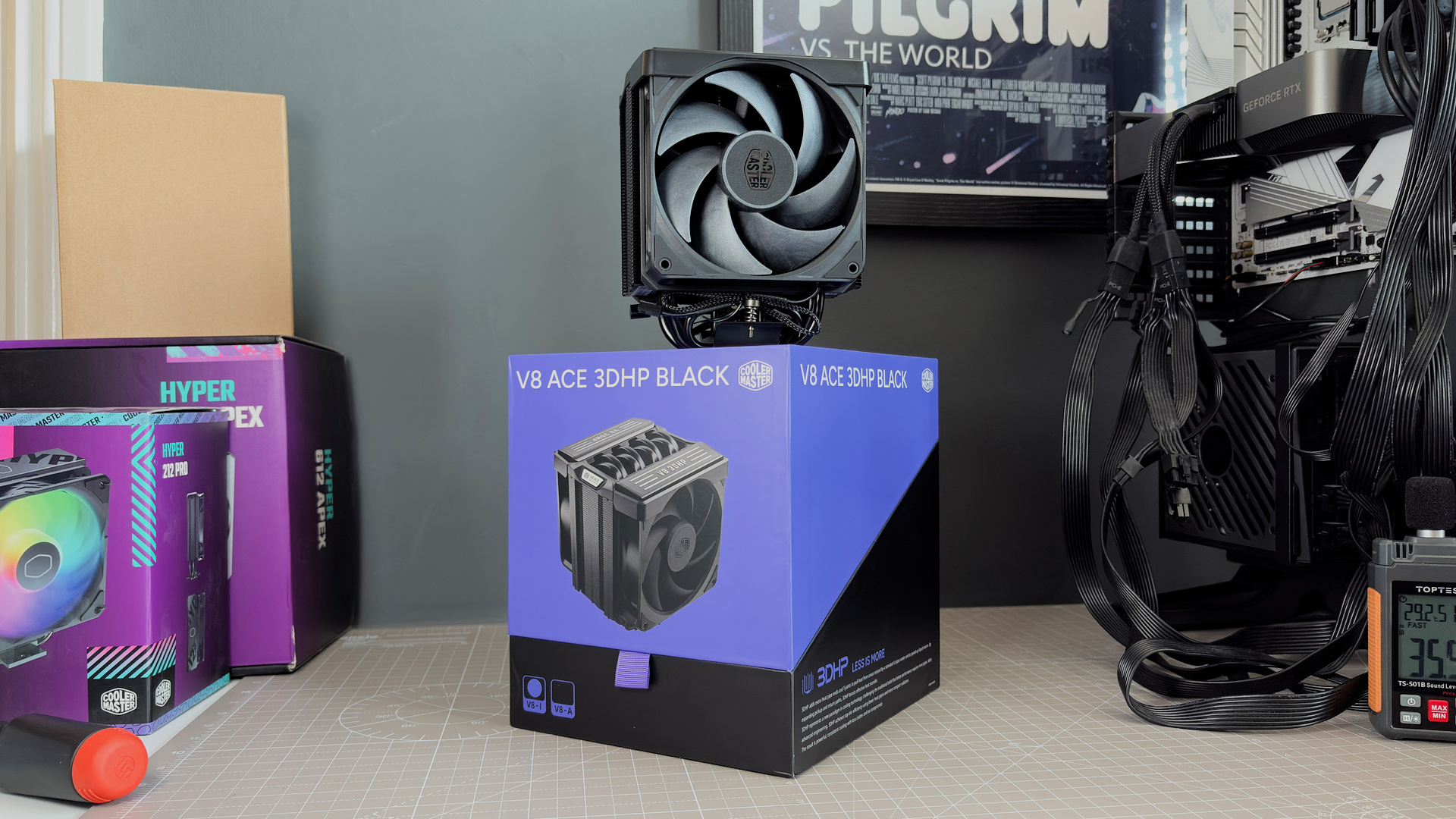 The Cooler Master V8 Ace 3DHP installed on a test bench and on its box.