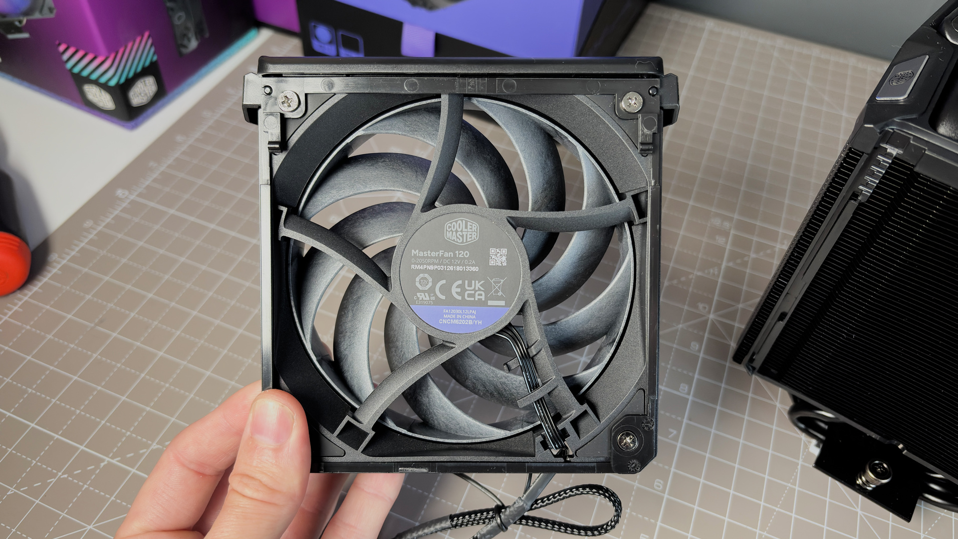 The Cooler Master V8 Ace 3DHP installed on a test bench and on its box.