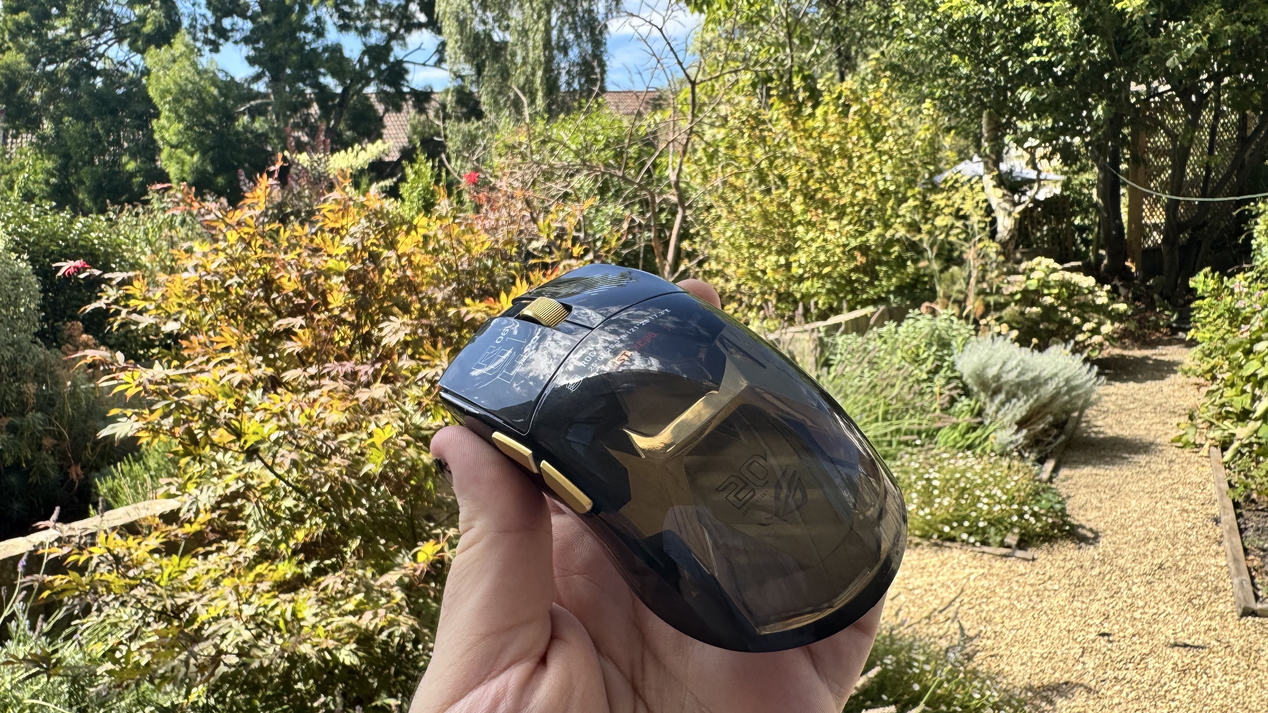 Asus ROG Harpe II Extreme Edition 20 in a hand outside, from the back left