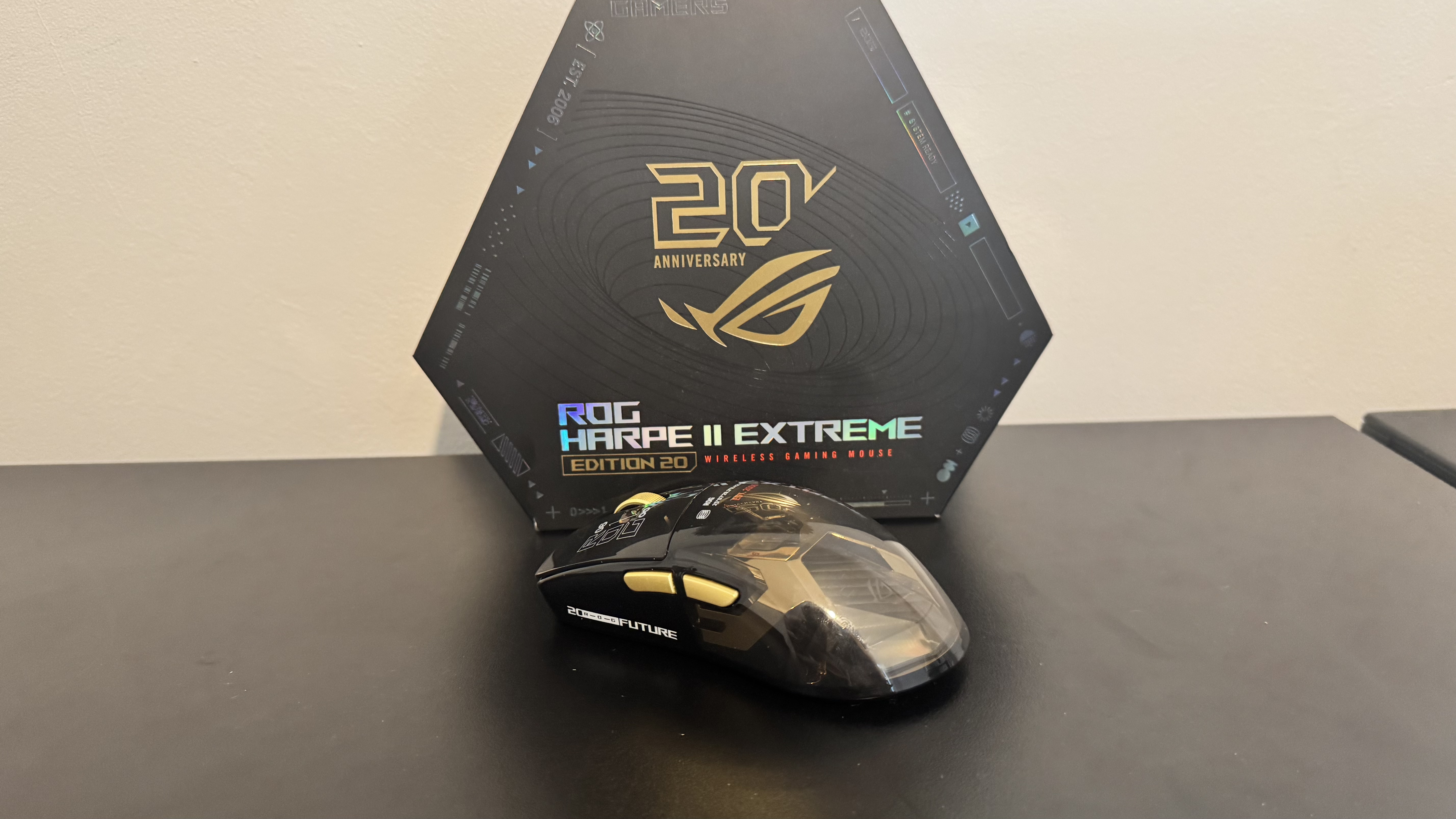 Asus ROG Harpe II Extreme Edition 20 on a black table, next to its box