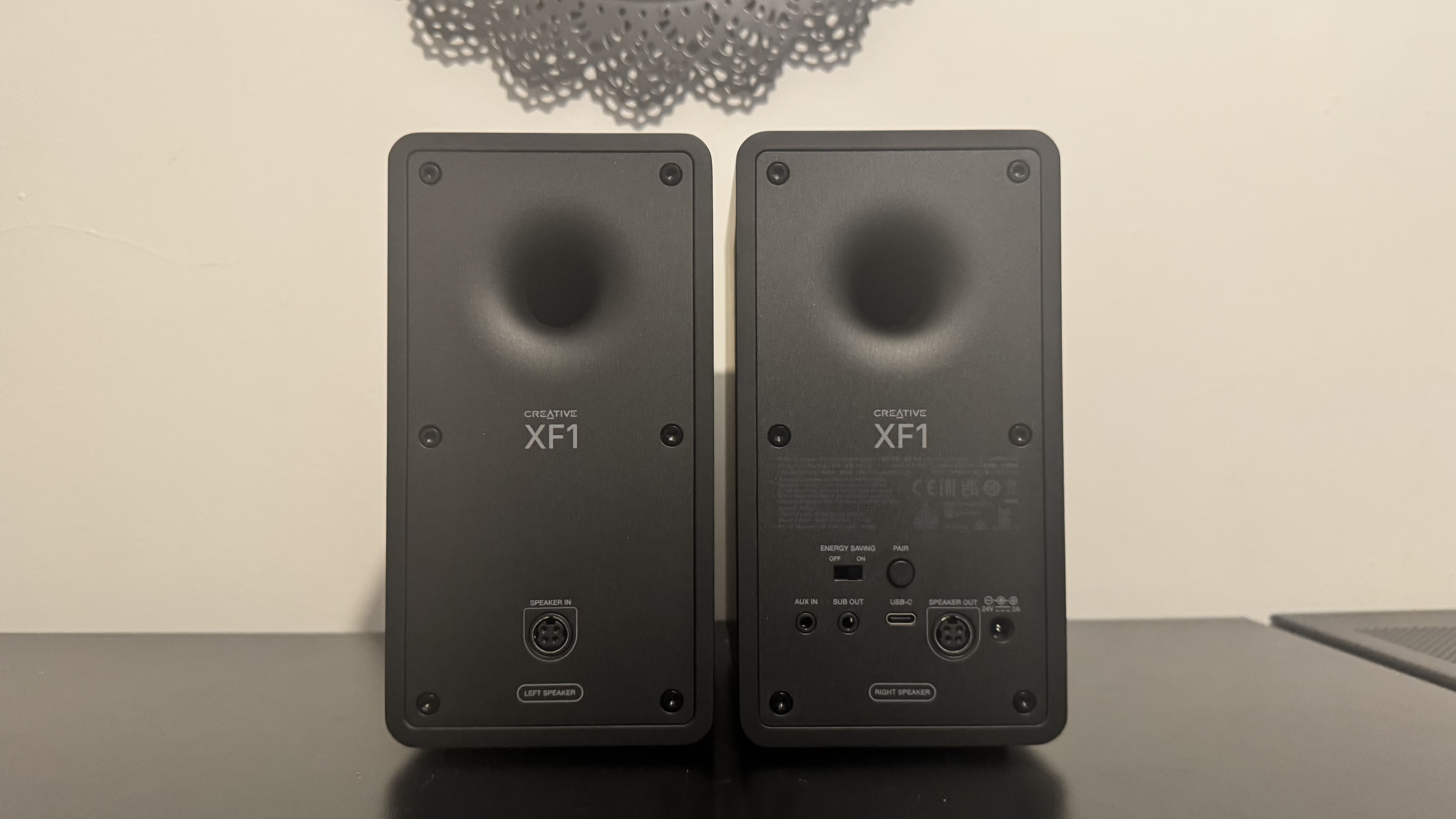 Creative XF1 speakers on a black desk
