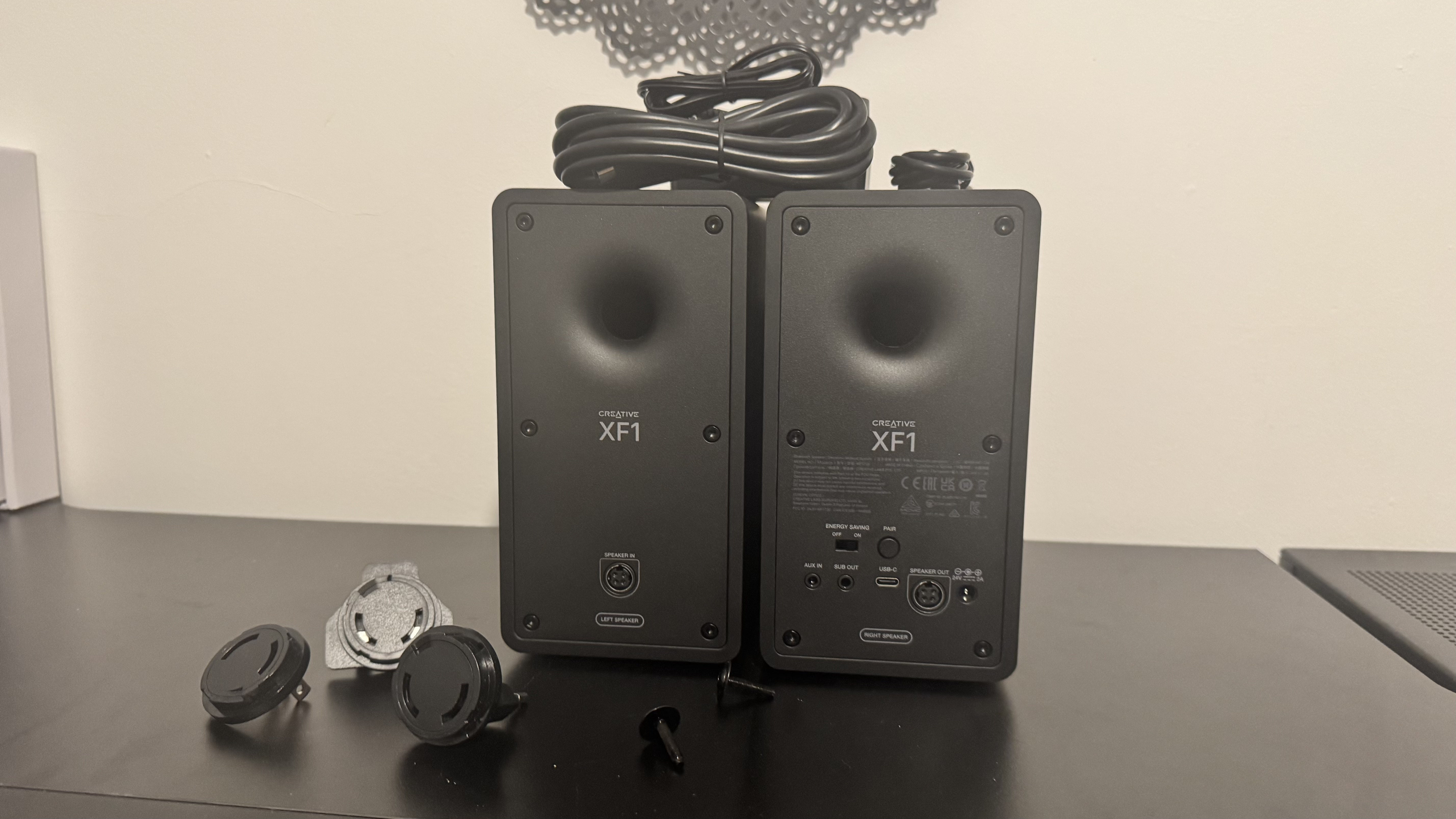 Creative XF1 speakers on a black desk