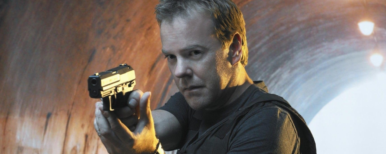 Kiefer Sutherland as Jack Bauer with a handgun drawn in 24.