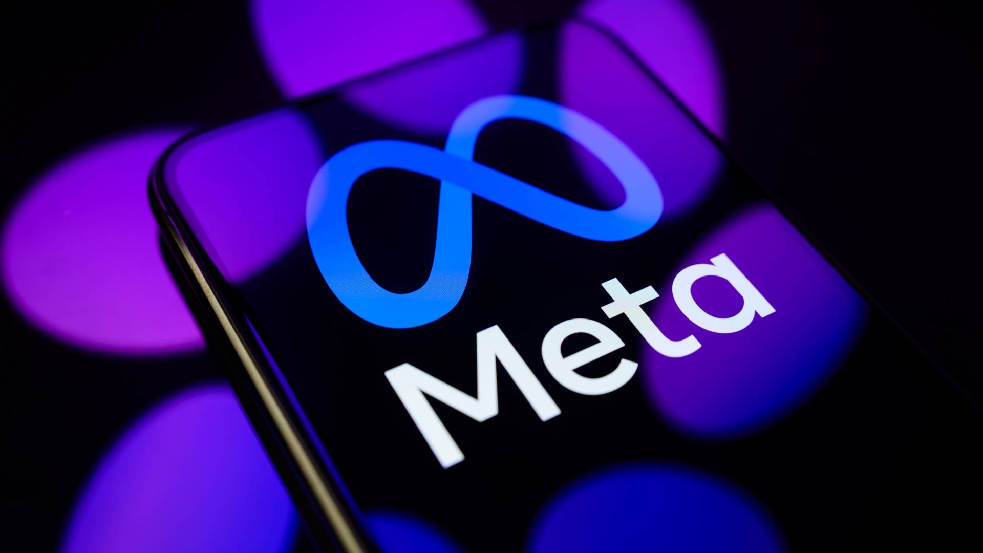 The Meta logo is displayed on a smartphone screen placed on a reflective surface onto which the Meta AI logo is projected, in Creteil, France, on July 9, 2026. Meta announces the launch of Muse Image, its first proprietary image generation model.