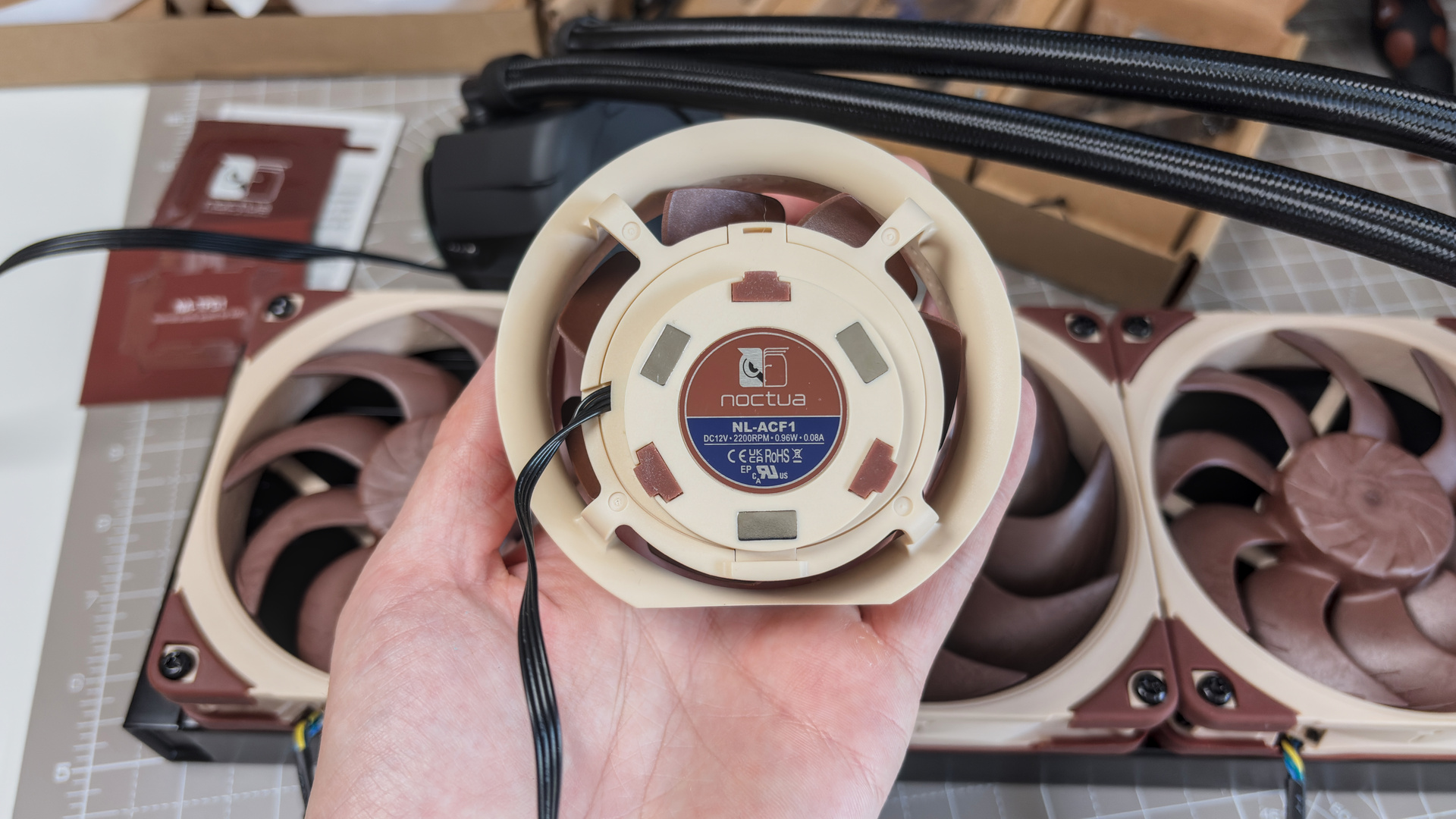 A Noctua NL-LC1 liquid cooler being installed on a test bench for testing.