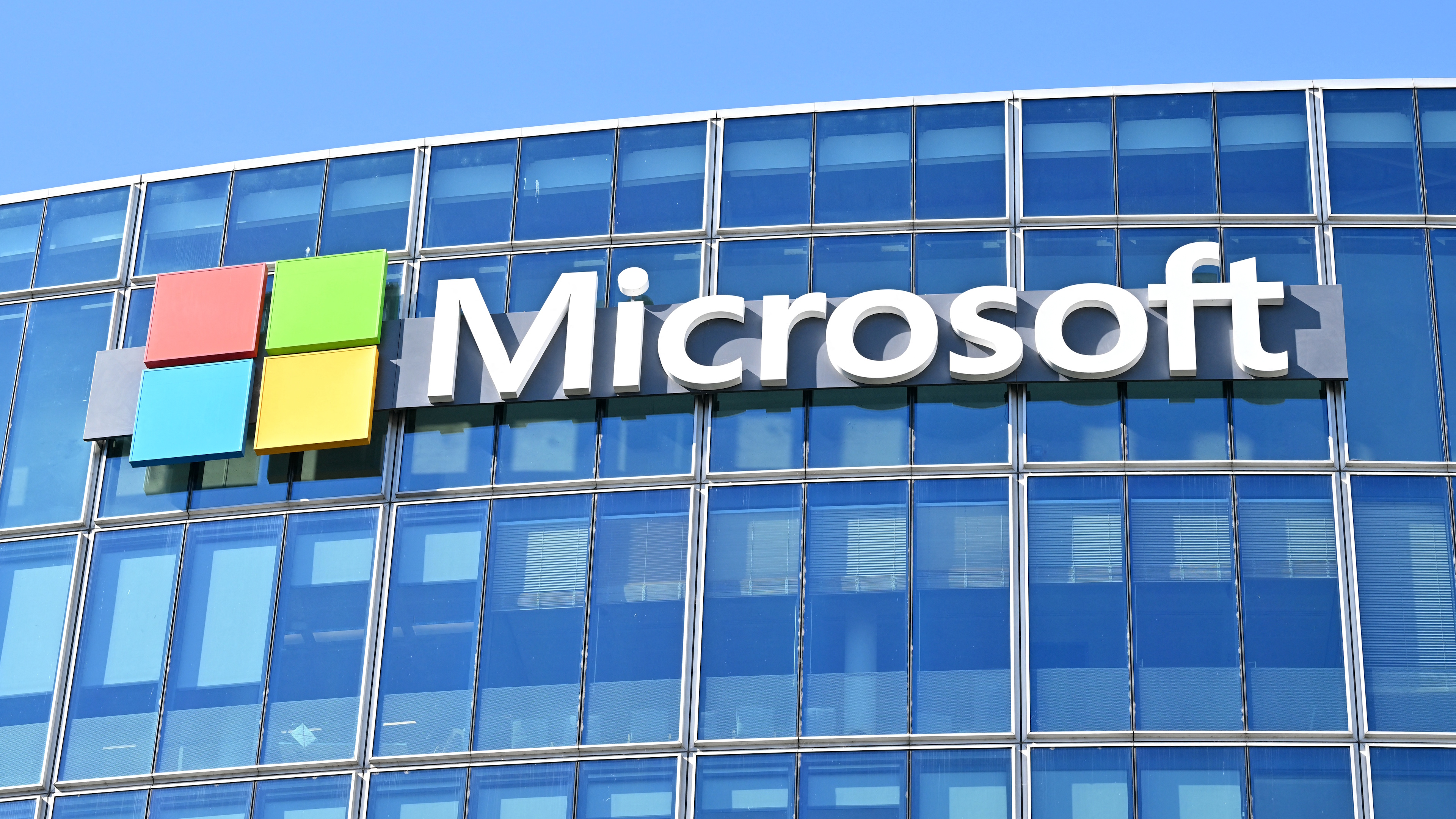 This photograph shows the logo of Microsoft displayed on the facade of the company France headquarters in Issy-les-Moulineaux, on the outskirts of Paris, on April 24, 2026. (Photo by Martin LELIEVRE / AFP via Getty Images)