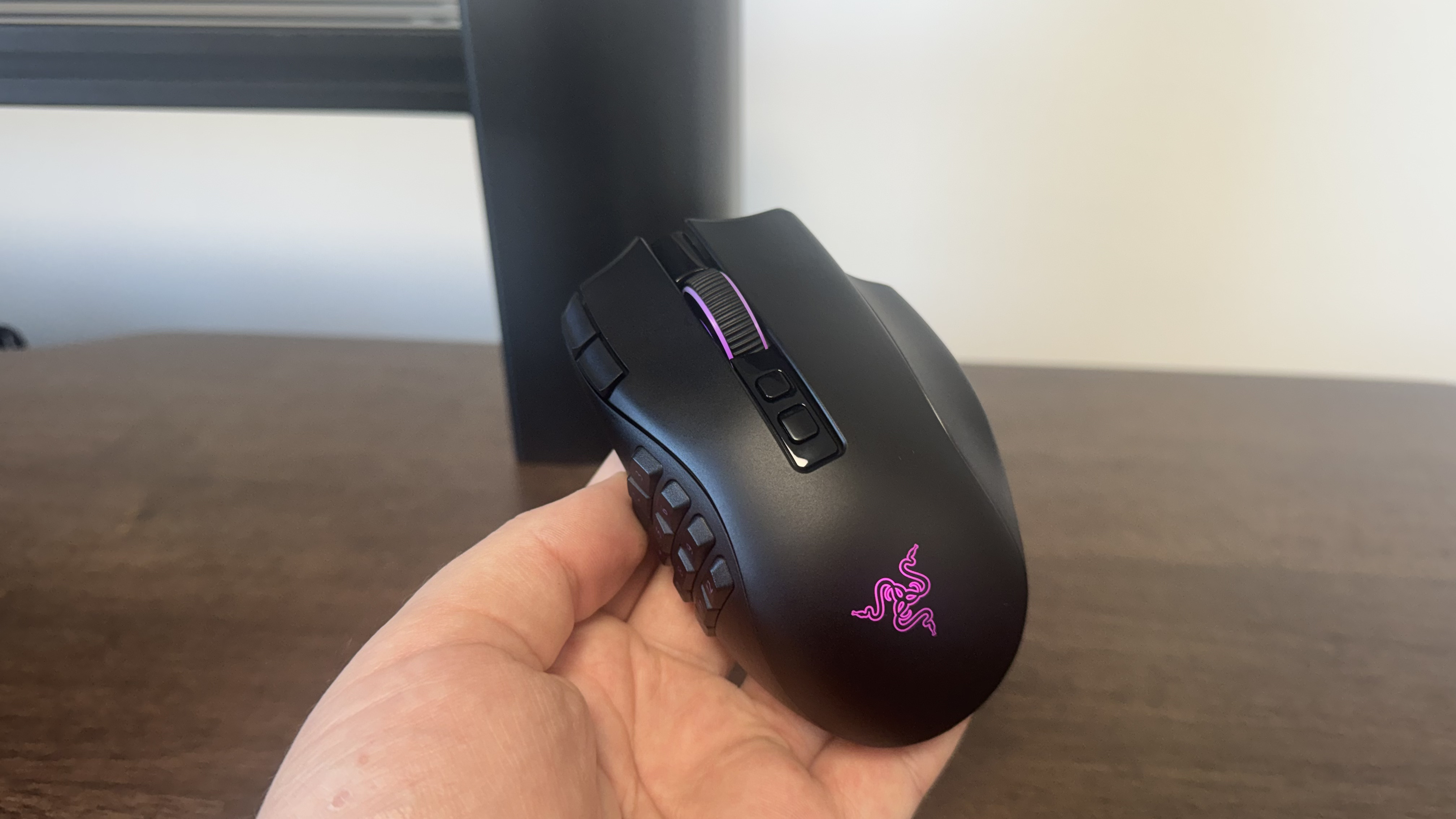 The Razer Naga V3 Pro in a hand, from the top