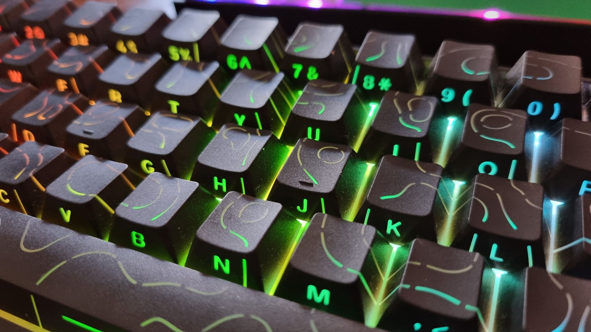 A Razer Reclusa X Mini 65% gaming keyboard shot from above, on a wooden desk