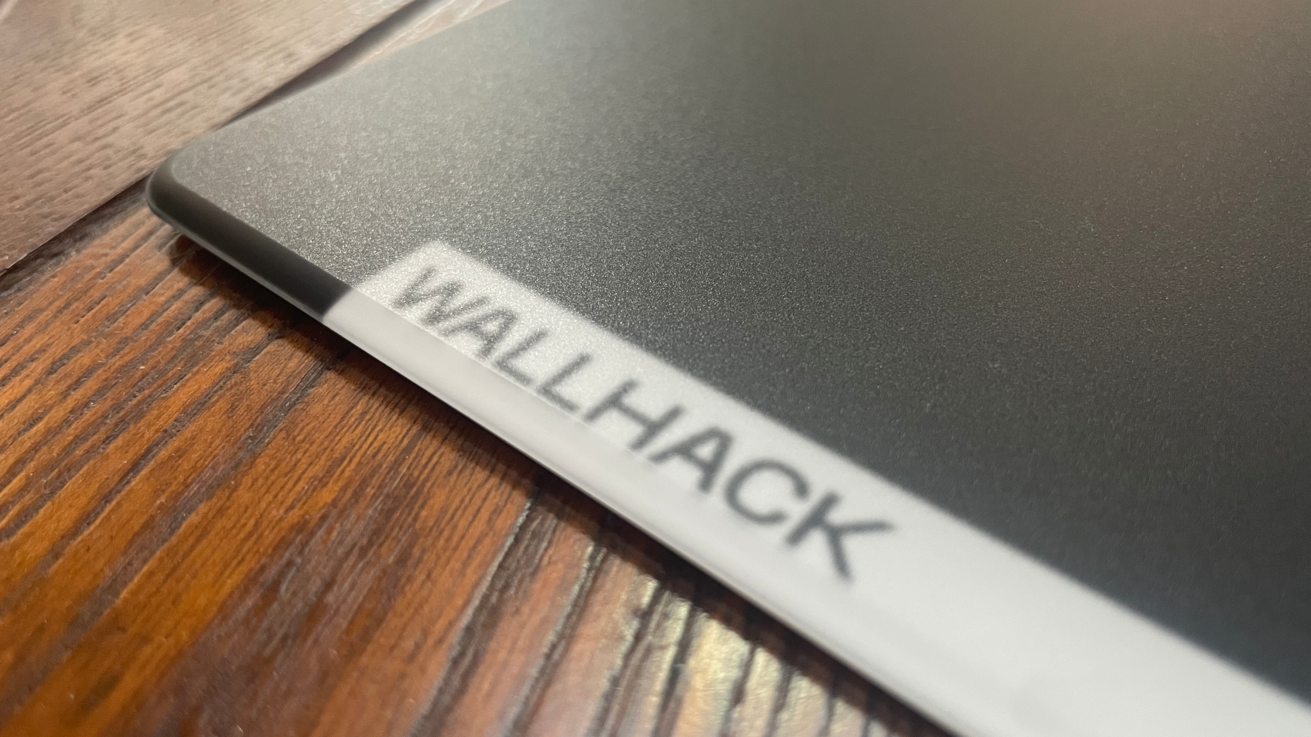 The corner of a Wallhack glass mouse pad.