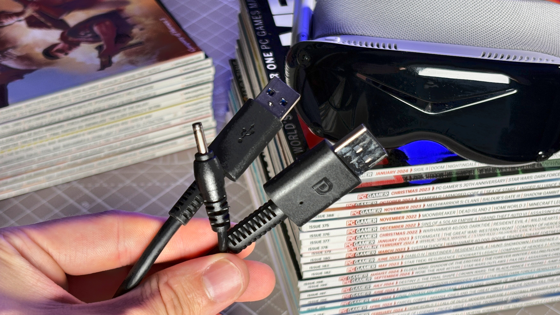 The Pimax Dream Air in white on a stack of PC Gamer magazine.