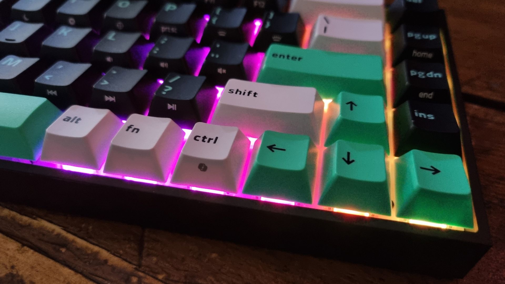 Close ups of the Razer Reclusa X Mini 65% gaming keyboard showing the RGB lighting effect