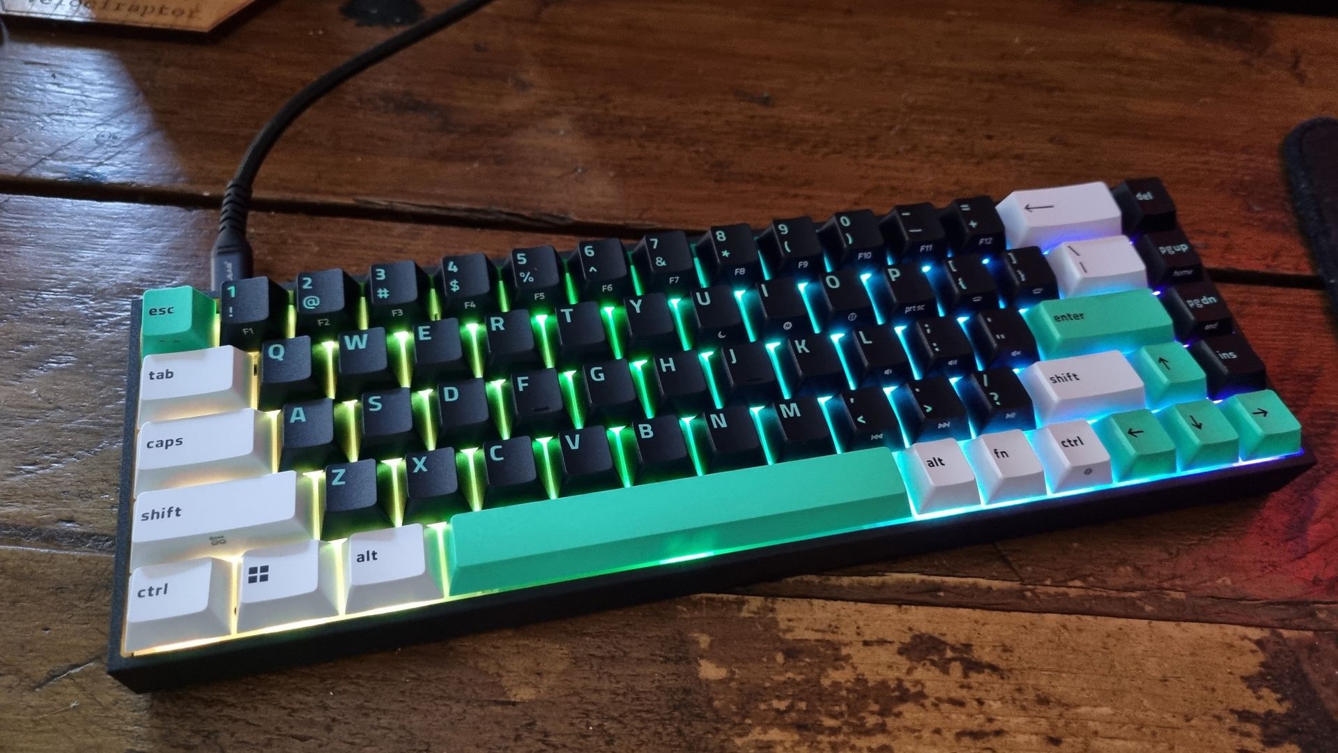 Close ups of the Razer Reclusa X Mini 65% gaming keyboard showing the RGB lighting effect