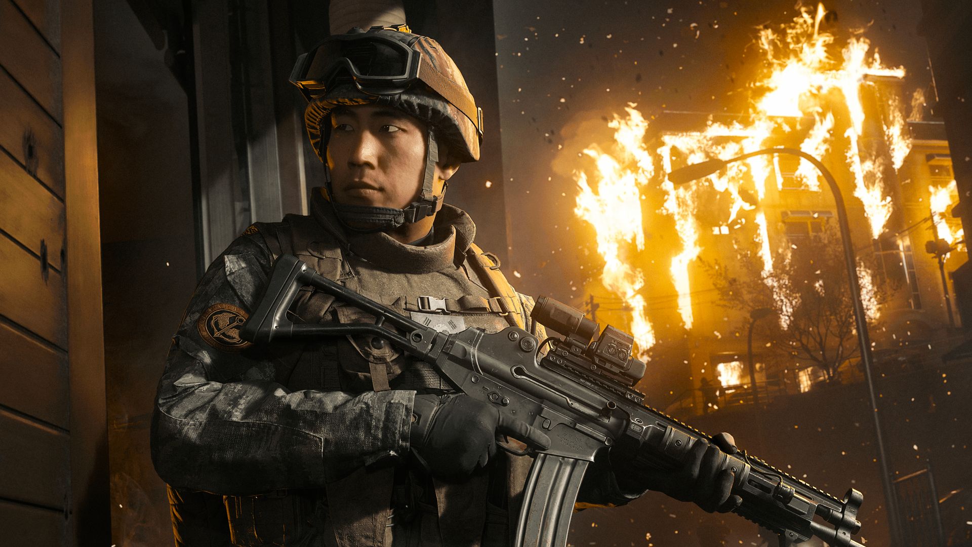Key art for MW4, depicting a Korean soldier cautiously stood next to a wall as a building burns in the background.